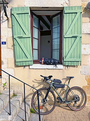Ein Gravelbike steht an eine Hauswand gelehnt. 