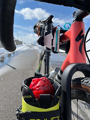 Velo Ski Tour in den Schweizer Alpen. Skischuhe an der Gabel eines Fahrrads befestigt.