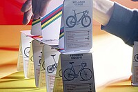 Ein Velokilometer kostet mehr, als man denkt. Kartenhaus mit Quartettkarten, auf denen Velos zu sehen sind.