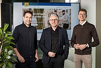 TCS übernimmt Velocorner. Drei Männer posieren für ein Foto. 